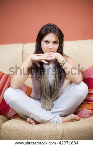 beautiful girl portrait sitting in the sofa of a living room