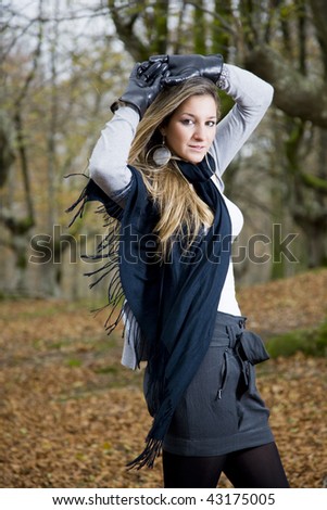 beautiful young fashion woman posing in an autumn forest