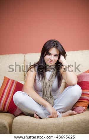 beautiful girl portrait sitting in the sofa of a living room