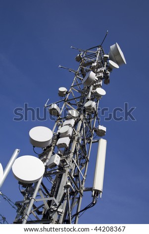 image of communication mobile internet antenna over a blue sky background
