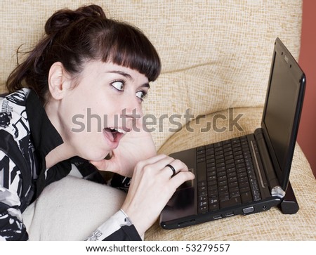 a real young woman typing in the keypad of a laptop