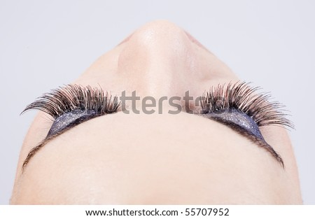 detail of the make up of eyelashes in a young beautiful girl