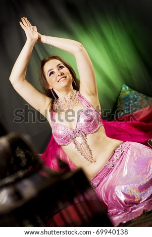 oriental woman laying on the floor with a pink dress and veils