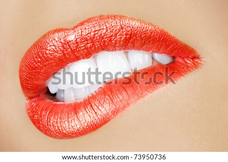 sensual mouth of a young woman bitting a lip in a sexy expression