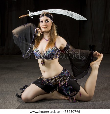 beautiful woman dancing the oriental style dance called belly dance