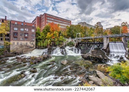 Hydro electric dam on Magog River in Sherbrooke city, Quebec, Canada with autumn colors