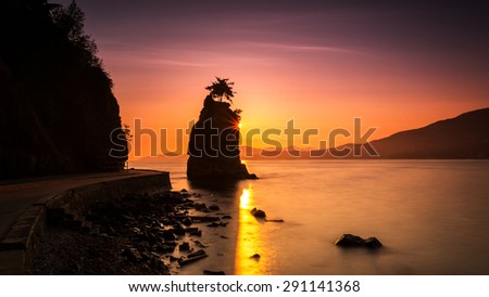 Silhouette of Siwash Rock at Sunset in the beautiful Stanley park, Vancouver, British columbia, Canada