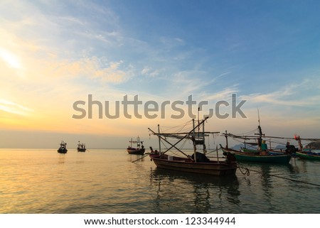 Fishing boats at sunset or sunrise, in Thailand.