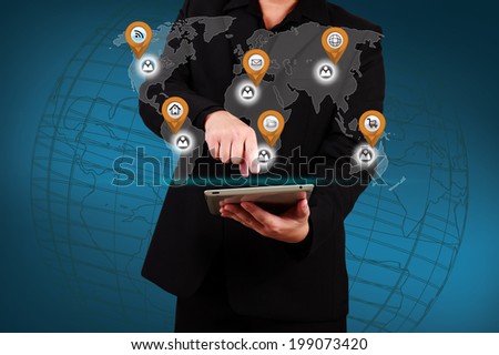 Businessman holding a tablet with virtual globe and business plan. Concept of business strategy