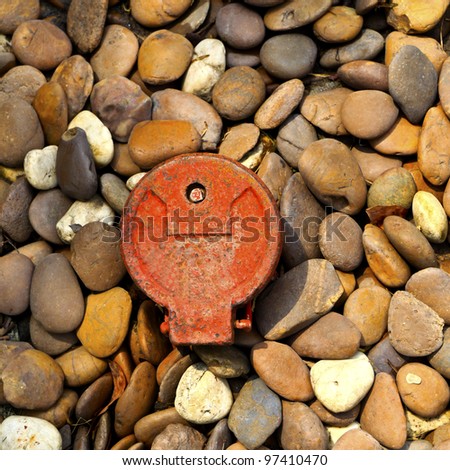 Natural pebble stones with old water meter.