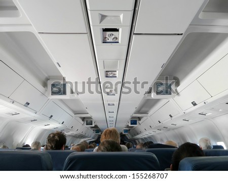 Airplane Interior - People Sitting On Seats