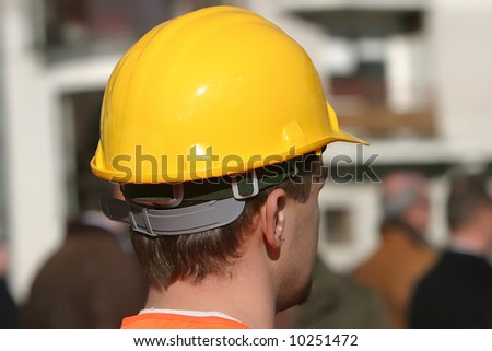 worker in a yellow plastic safety hard hat
