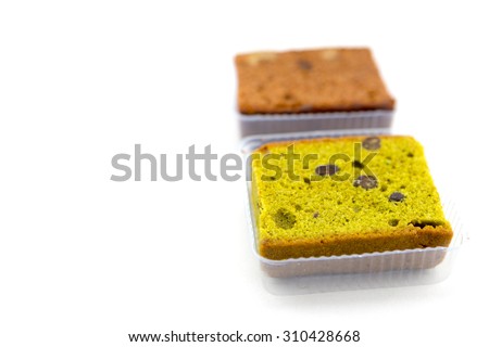Chocolate and Japanese Green tea pound cake with raisins in plastic package, isolated on white.
