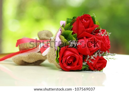 Beautiful Bouquet Of Bright Red Flowers, On Table On Green Background