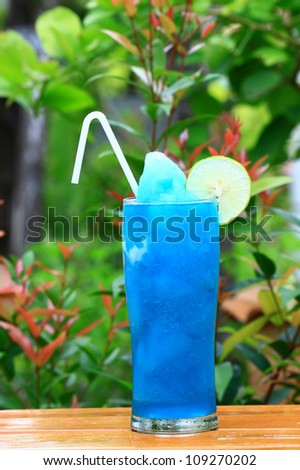 Blue Hawaiian cocktail blend with lemon and green background