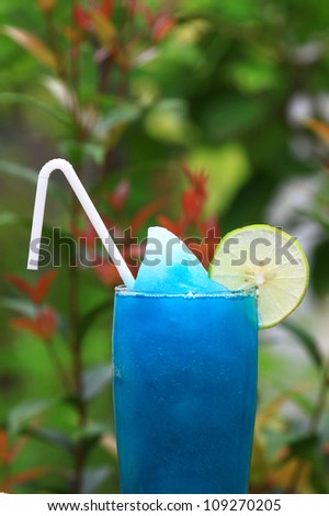 Blue Hawaiian cocktail blend with lemon with green background