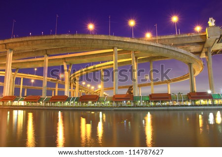 Bhumibol Bridge in Thailand, also known as the Industrial Ring Road Bridge, in Thailand. The bridge crosses the Chao Phraya River twice at twilight.