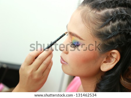 Eye makeup woman applying eyeshadow powder.