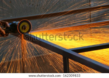 Electric wheel cutting on steel structure in factory