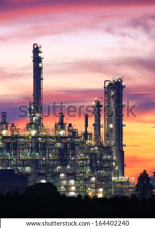 Tower of oil refinery at twilight sunrise