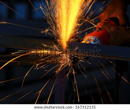 Electric wheel cutting on steel structure in factory