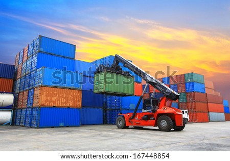 forklift handling the container box at dockyard with beautiful sky