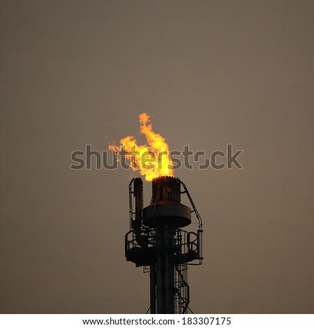 Heavy smoke from industrial chimney polluting the environment at night