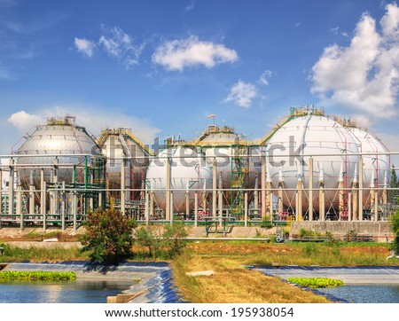 big Industrial oil tanks in a refinery with treatment pond at industrial plants