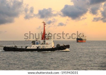 Cargo Ship and Tugboat in the morning