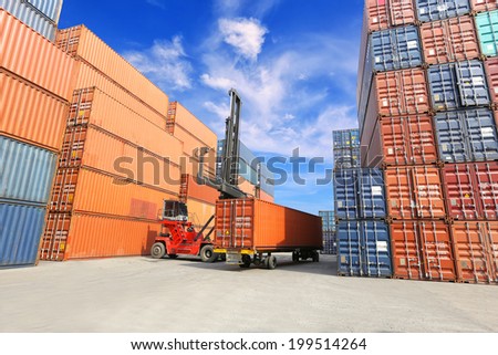forklift handling the reefer container box at dockyard