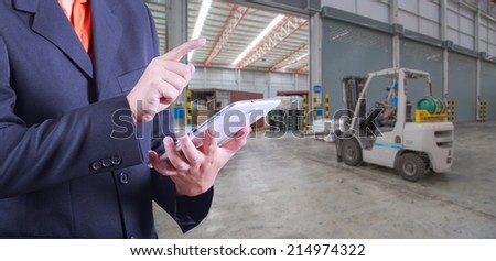 tablet to handle export and import goods prepare the delivery of product at dock in warehouse