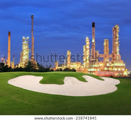 Sand bunker for golf sport with petrochemical plant at night background
