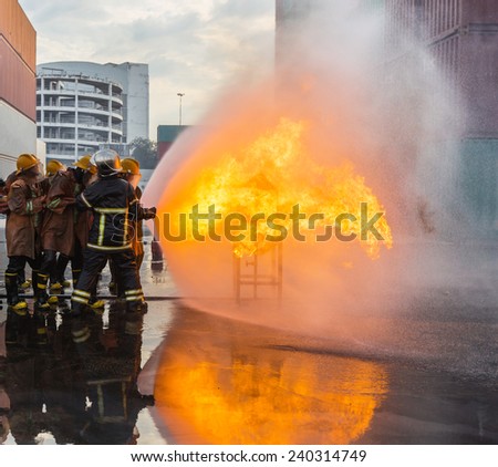 Firefighters prepare to attack a propane fire at container yard
