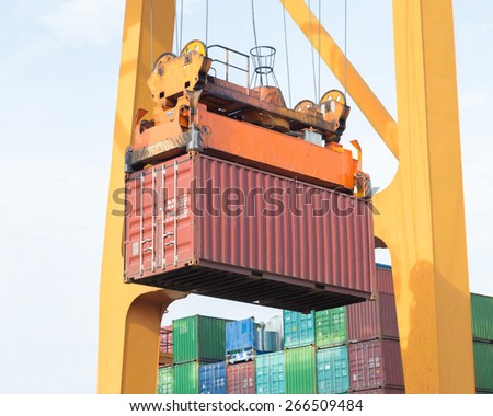 Sea container lifted by a harbor crane at ship yard
