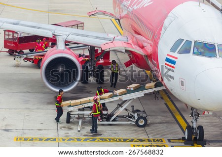BANGKOK, THAILAND - April 11, 2014: unloading of baggage from the Airasia aircraft in Bangkok airport on April 11, 2014. Air Asia company is the largest low cost airlines in Asia.