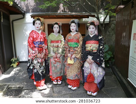 KYOTO - May 20, 2015: four young beautiful Japanese women called Geisha wear a traditional dress called Kimono on May 20, 2015 in Gion, Kyoto, Japan.