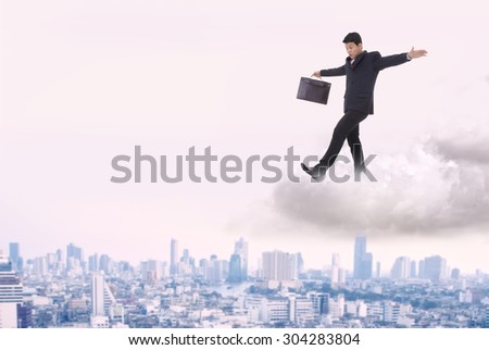 Businessman walking on a cloud near miss.