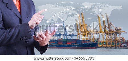 hand presses on world map with digital tablet,Industrial Container Cargo freight ship at dusk for Logistic Import Export background (Elements of this image furnished by NASA)