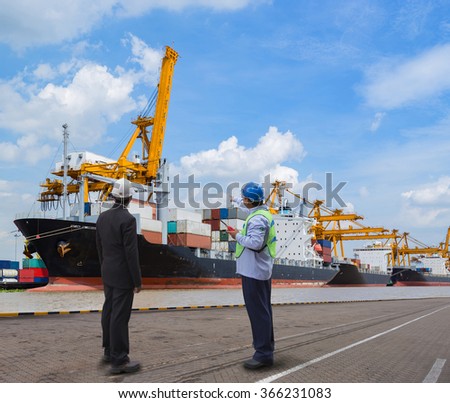 foreman control Industrial Container Cargo freight ship from his manager with working crane bridge in shipyard with truck