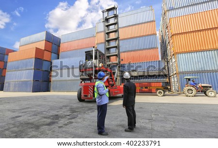 foreman control forklift handling follow order from his manager for move the container box loading at dock yard