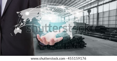 Global network coverage world map on hand of businessman ,Industrial steel pipes for Logistic Import Export background (Elements of this image furnished by NASA)