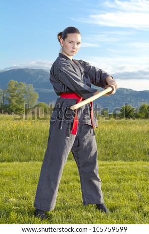 Woman ninja in an aggressive posture with a katana sword