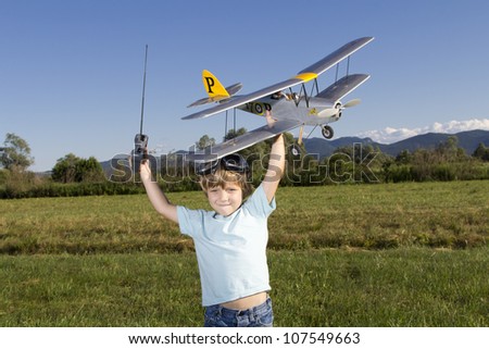 Smiling happy young boy preparing to launch RC plane
