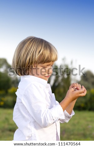 Crying young boy with finger injury outdoors