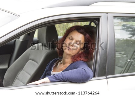 Tired woman driver sleeps in the car