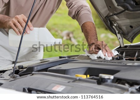 Vehicle maintenance - Filling the windshield washer fluid on a Car