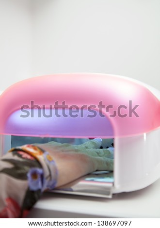 Drying in Nail enamel drying device, Making nail extension, Drying of enamel, series of STEP BY STEP nail extension process HIGH RESOLUTION photos, Closeup, selective focus