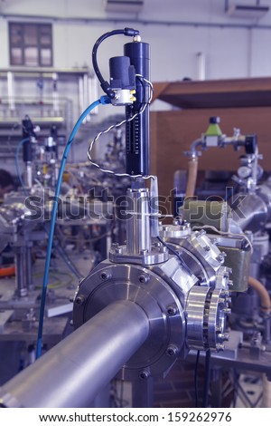 View of Important electronic and mechanical parts of Mass spectrometer in ION Accelerator command room, CNC machined parts, selective focus,  tilt shift lens,  industrial blue toned