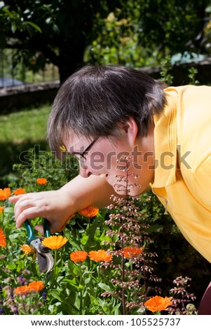 mentally disabled woman cut flowers in the garden
