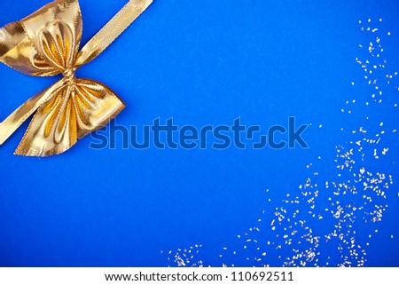 a blue card with golden ribbon